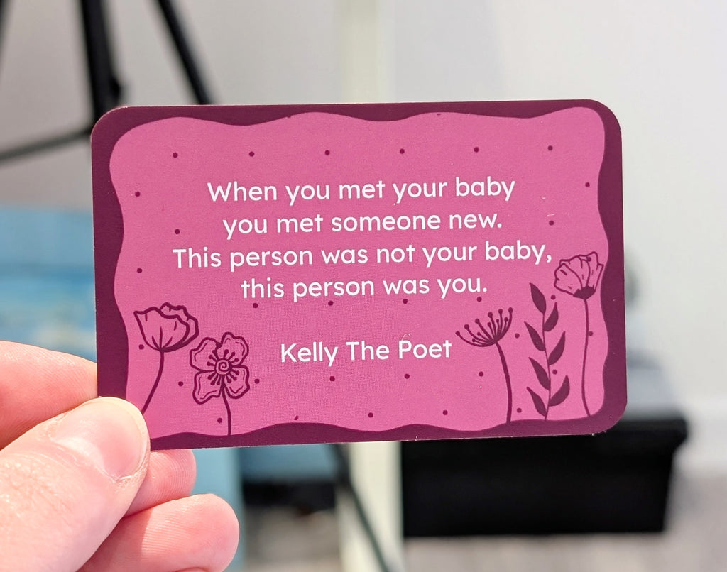 Pink card with a quote for new mums by Kelly The Poet held by a hand