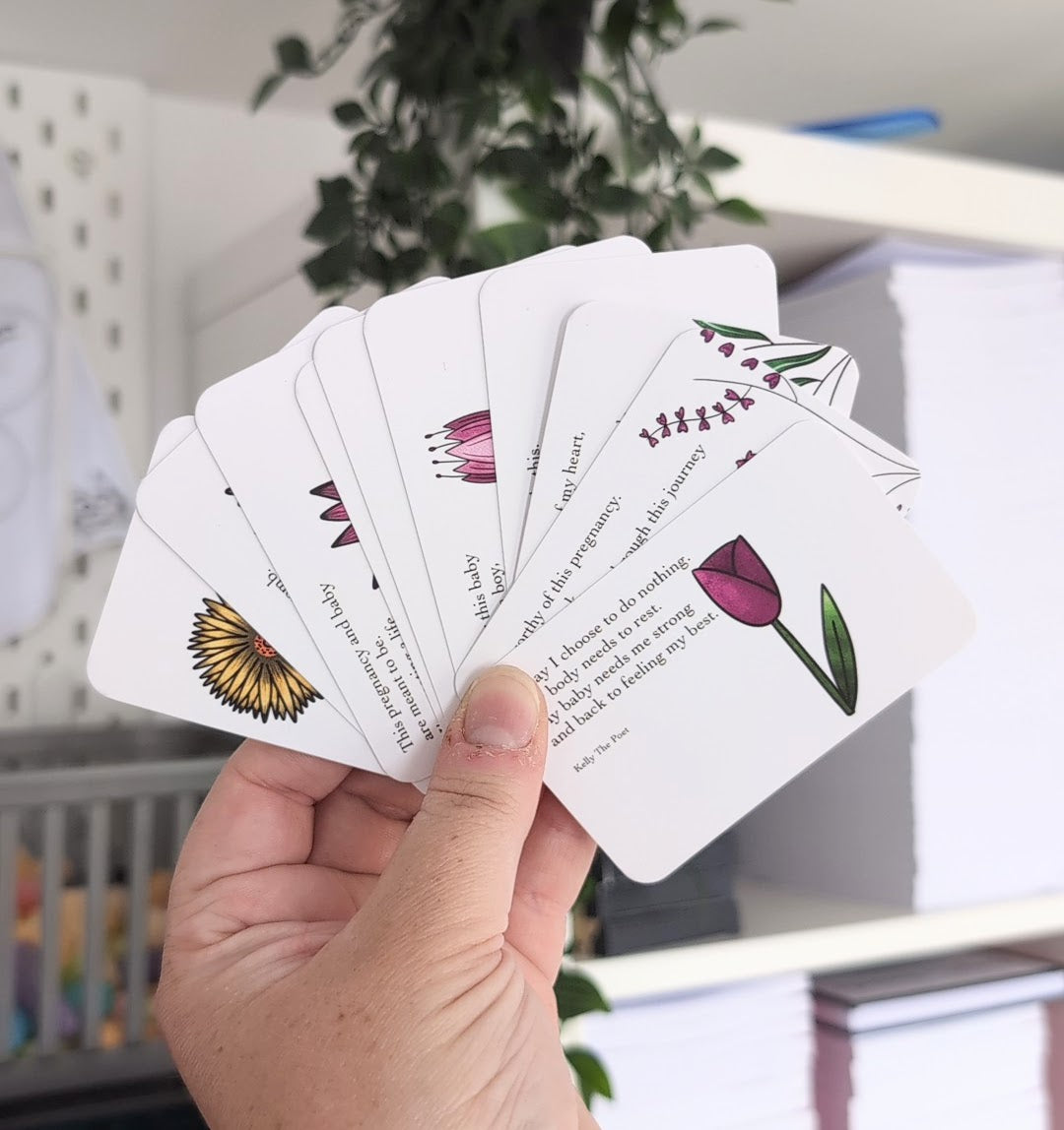 A hand holding a series of folded cards with poems written on them, each card has a different floral illustration at the bottom.